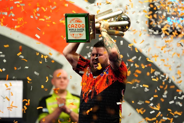 Michael Smith celebrates with the Sid Waddell Trophy