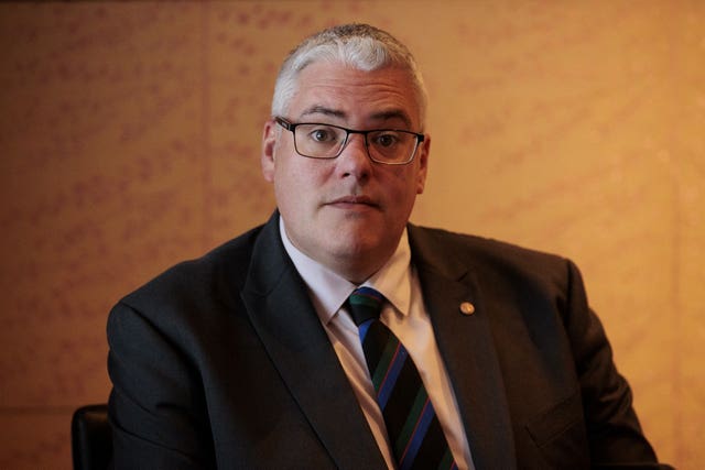 DUP leader Gavin Robinson looks at the camera