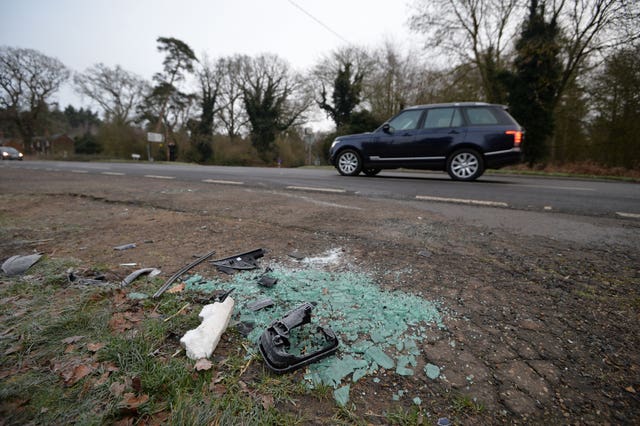 Broken glass and car parts on the side of the A149 