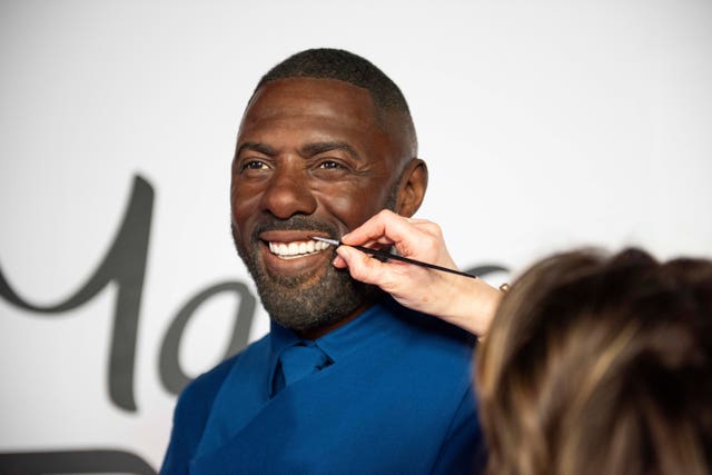 An artist touches up Idris Elba’s waxwork figure at the Baker Street attraction in London
