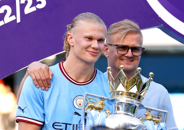 Erling, left, and Alf-Inge Haaland pose with the Premier League trophy