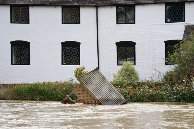A garden arbour floats in the River Severn 