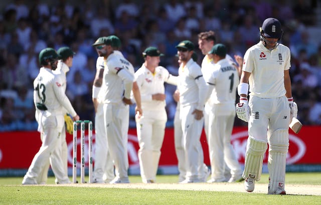 Rory Burns, centre right, walks off dejected after being dismissed