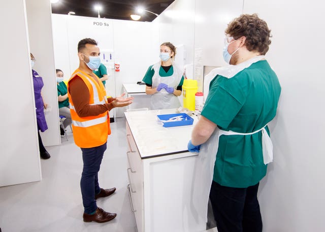 Dr Amir Khan during a tour of the Elland Road vaccine centre in Leeds