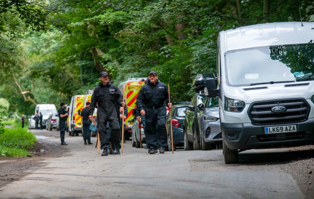 Police officers searching the land at Sand Hutton Gravel Pits near York in connection with the disappearance of missing university chef Claudia Lawrence 