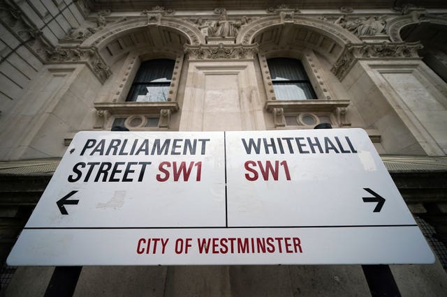 A City of Westminster street sign for Parliament Street on the left and Whitehall on the right