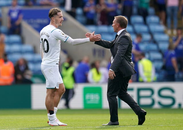 Leicester manager Brendan Rodgers shakes hands with Jack Grealish