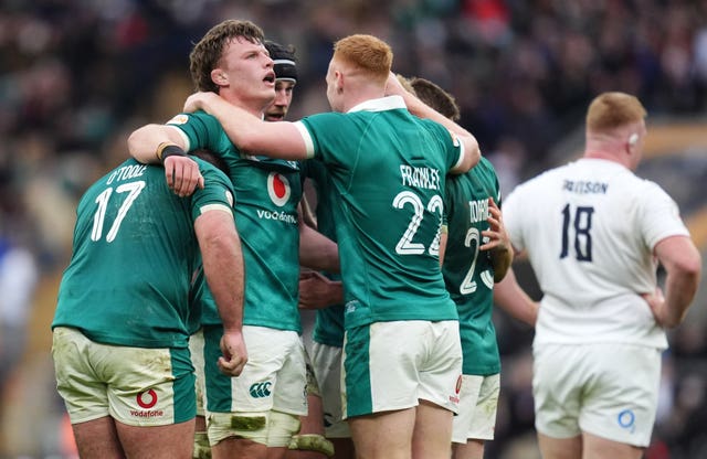 Ireland players celebrate the win as England players appear dejected