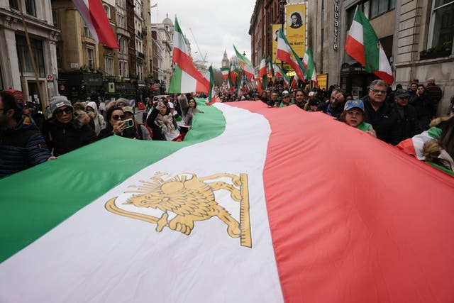A giant Iranian flag is carried during a protest
