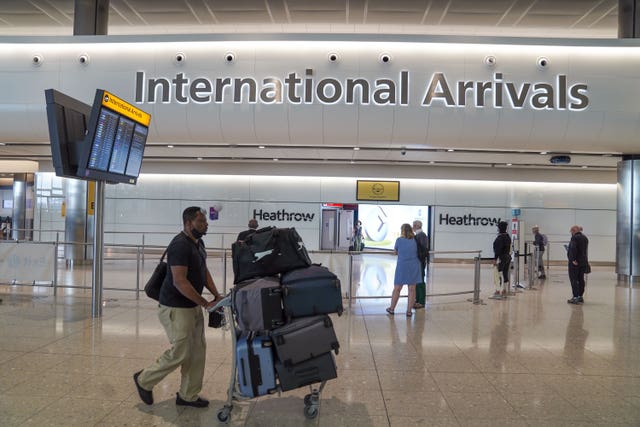 Passengers in the international arrivals hall at Terminal 2 of London Heathrow Airport