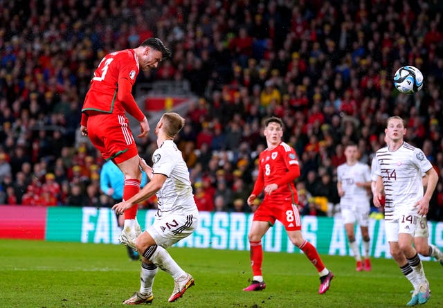 Kieffer Moore, left, heads Wales in front against Latvia