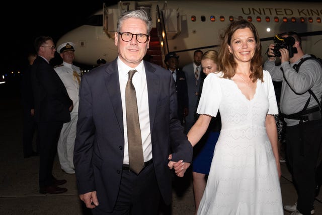 Sir Keir Starmer holding his wife, Lady Victoria Starmer's hand