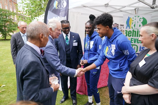 The King shakes hands with members of the Big Kid project during a reception at Clarence House, London, to celebrate four decades of the Prince of Wales’s Charitable Fund 