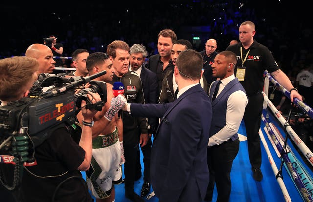 Khan (left) and Brook speak in the ring at Liverpool's Echo Arena