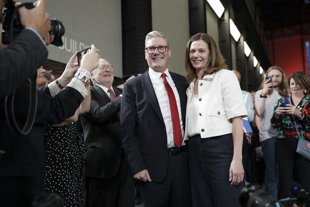 Sir Keir Starmer and his wife, Victoria, pose for photographs during Labour's election victory event at the Tate Modern