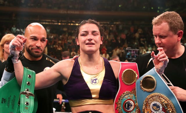 Katie Taylor celebrates with her title belts after beating Delfine Persoon