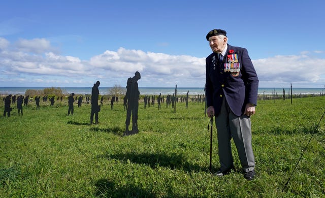 D-Day veteran Mervyn Kersh among the Standing with Giants silhouettes at the British Normandy Memorial, in Ver-Sur-Mer, France in 2024