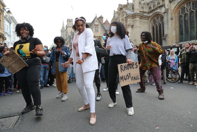 People during a protest calling for the removal of the statue of 19th century imperialist, politician Cecil Rhodes from an Oxford college which has reignited amid anti-racism demonstrations
