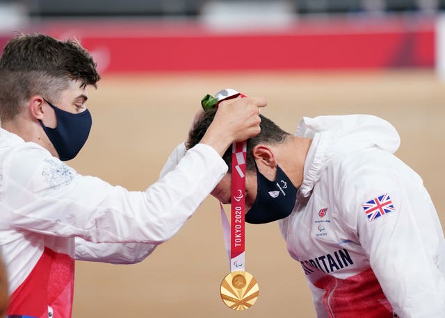 Jaco Van Gass, right, receives his gold medal from team-mate Fin Graham, who took silver