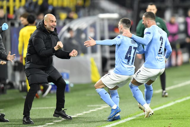 Pep Guardiola celebrates with Phil Foden after his Champions League goal against Borussia Dortmund