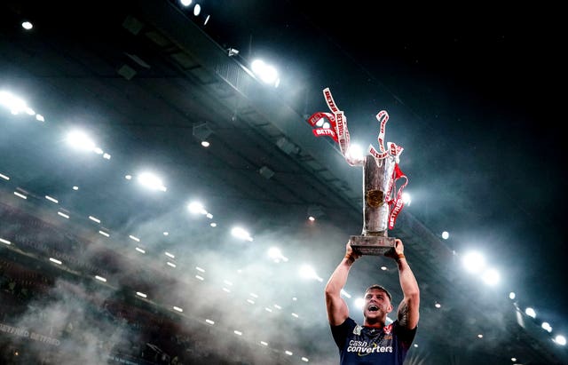St Helens’ Morgan Knowles lifts the trophy after his side won the Super League Grand Final at Old Trafford. St Helen’s, contesting the match for a record 13th time, beat Catalan Dragons 12-10