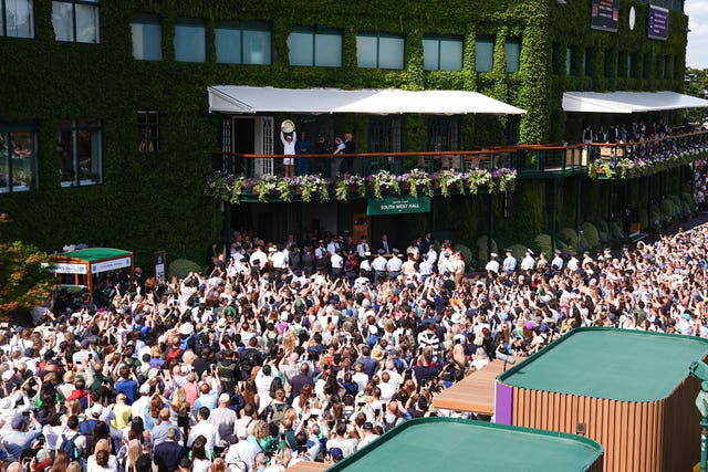 Barbora Krejcikova shows the Venus Rosewater Dish to the crowd