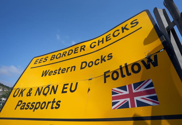 A yellow road sign reading 'EES border checks'