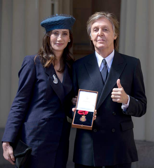 Sir Paul McCartney and his wife Nancy Shevell following an Investiture ceremony at Buckingham Palace, London, where he was made a Companion of Honour (Steve Parsons/PA)