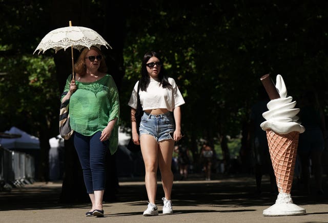 People walk past an ice cream display on South Bank in central London