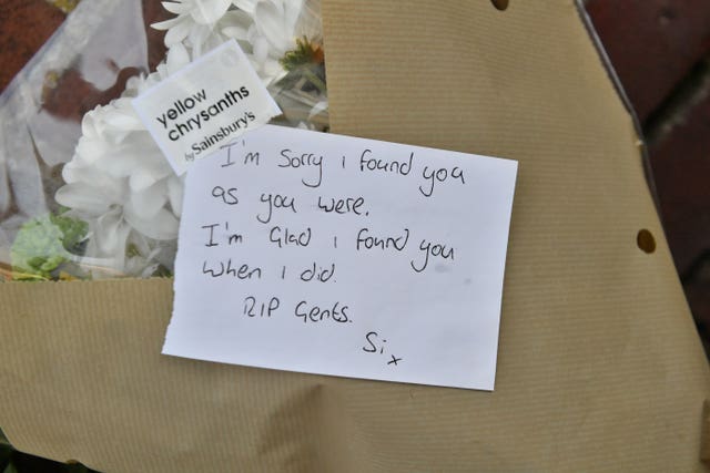 Floral tributes have been left outside the home of the twin brothers (Ben Birchall/PA)