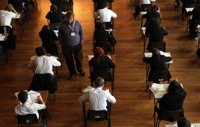 Pupils sit in an exam hall