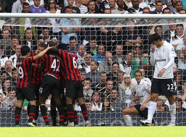 Tottenham's Vedran Corluka reacts as Manchester City players celebrate during their 5-1 win in August 2012