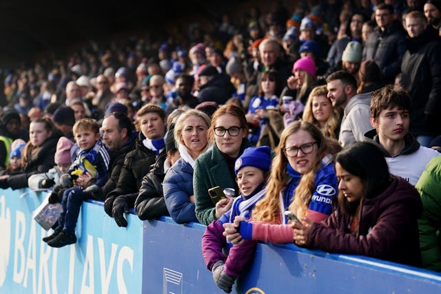 Fans watch on during the Barclays Women’s Super League match at Kingsmeadow, London