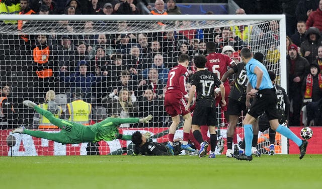 Paris St Germain’s Marquinhos, centre, slides in to prevent a Liverpool goal