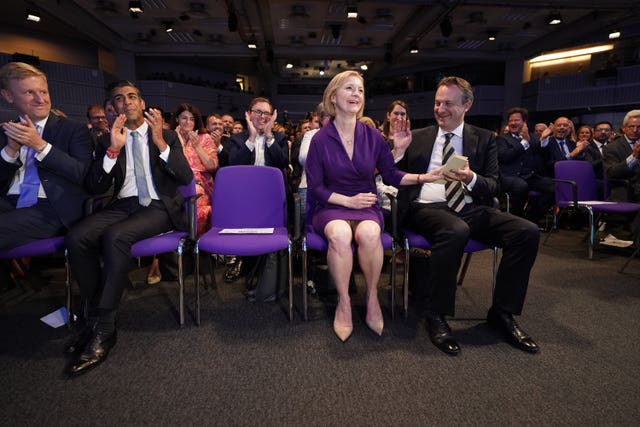 Left to right, Oliver Dowden, Rishi Sunak, Liz Truss, and her husband Hugh O’Leary, at the Queen Elizabeth II Centre in London as it was announced that Ms Truss is the new Conservative Party leader and will become the next prime minister
