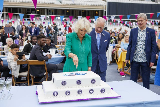 Charles and Camilla cut a cake