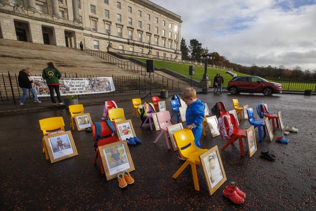 Cuan Conlon, two, runs through children’s seats at Stormont before a planned demonstration outside Parliament Buildings
