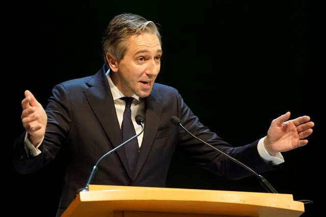 Taoiseach Simon Harris speaking from behind a lectern