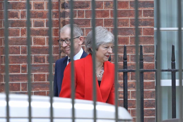 Theresa May leaves Downing Street with her husband Philip