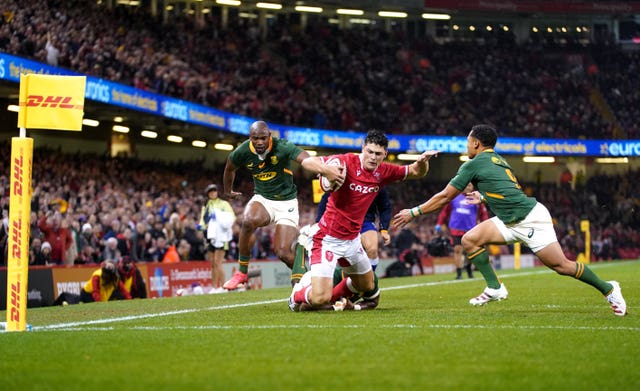 Louis Rees-Zammit is tackled short of the line by South Africa’s Siya Kolisi