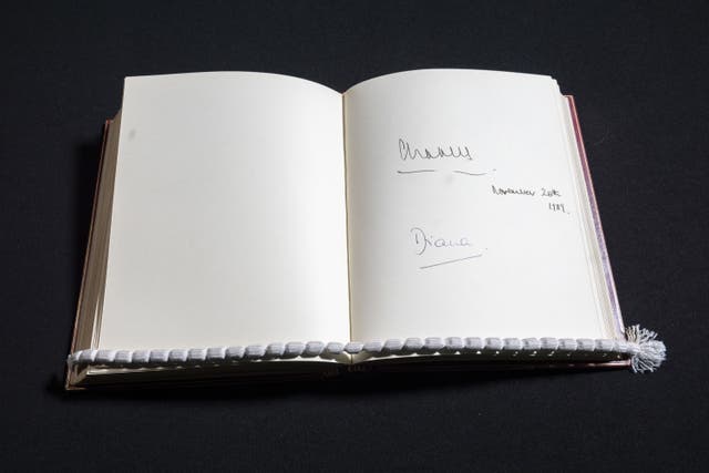 The signatures of then-Prince of Wales, now King, and his then wife Diana, Princess of Wales, when they visited 10 Downing Street on November 20 1989 are seen in one of three Downing Street Visitors Books at the National Archives 