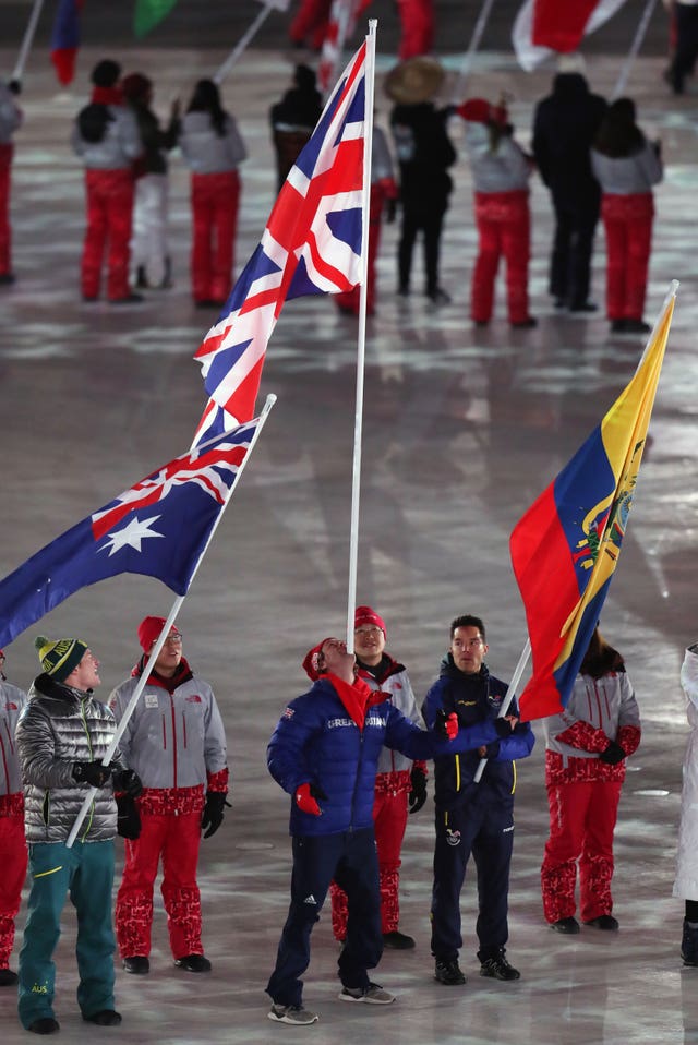 Great Britain’s flagbearer Billy Morgan (centre) balances the flag on his chin during the closing ceremony of the Pyeongchang 2018 Winter Olympic Games