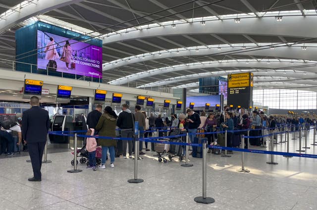 Passengers waiting to check in at Heathrow Airport 