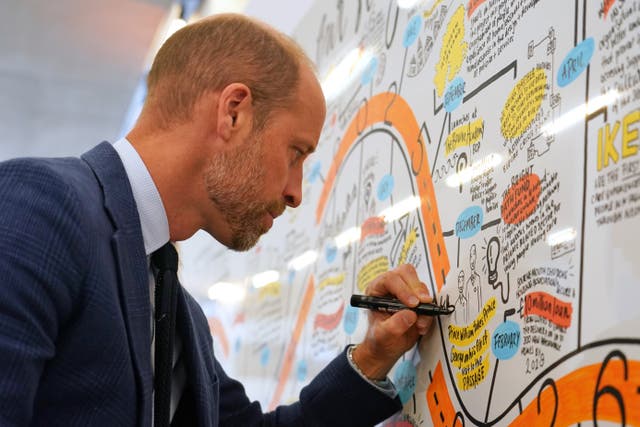 William puts his signature on a board during the Homewards event