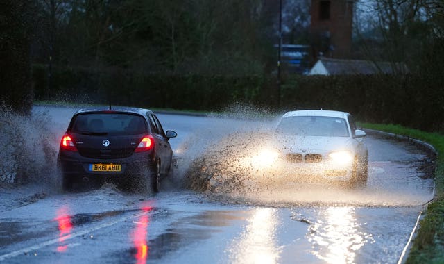 Motorists drive through standing water in Upton upon Severn, Worcestershire