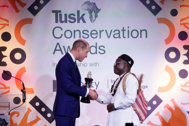 William presents Dr Ekwoge Abwe, from Cameron, with the Prince William Award for Conservation in Africa 