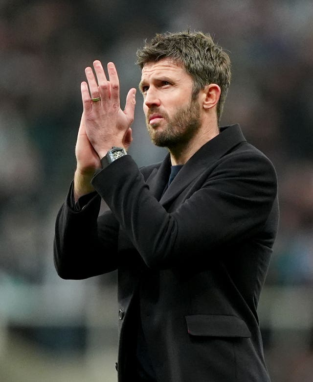 Michael Carrick applauds the fans