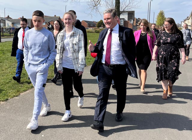 Sir Keir Starmer talks to young people as he walks through Southwick