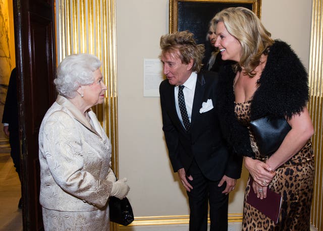 Queen Elizabeth II meeting Sir Rod Stewart and his wife Penny Lancaster during an award ceremony at the Royal Academy of Arts in 2016 