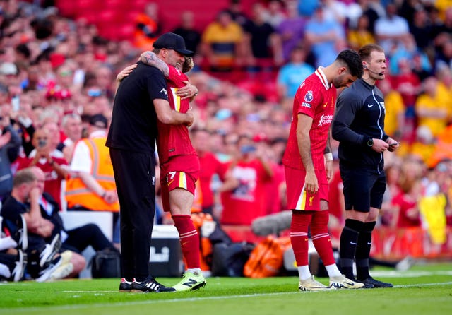 Liverpool’s Harvey Elliott is hugged by manager Jurgen Klopp